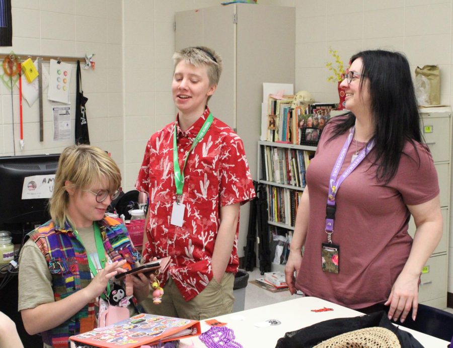 Mrs. Woodcock helps two AP art students with their new project.