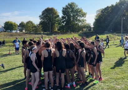 Senior Paul Cormany breaks it down pre-meet for the JV. Going into the last home meet of the season on senior night and conference, Cormany had the honors of breaking down the huddle. Cormany also led the dogs JV on the course finishing ninth with a time of 17:01. 
