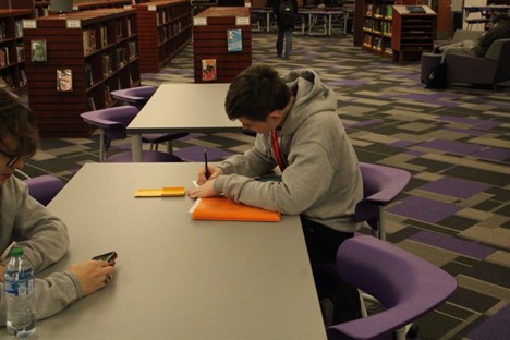 Students in the library are taking their time to study for classes. 