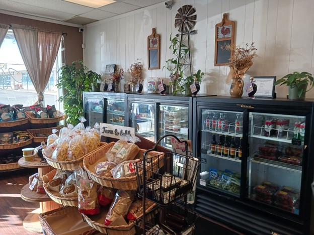 A look inside the store, in front of the bakery. The mini fridges have a variety of drinks and food offered at The Hayloft.