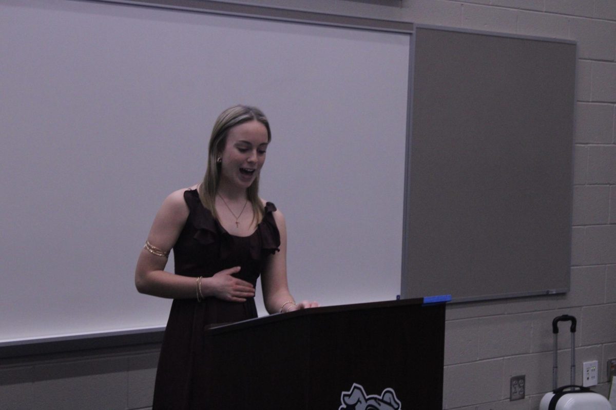 Junior Dani Tiehen gives a toast speech about one of her good friends, laughing about some of their memories . 