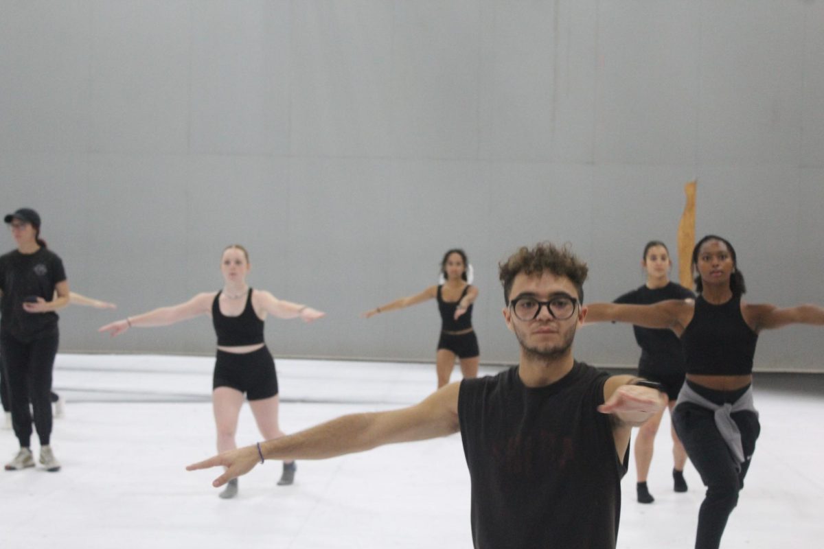 Senior Mauricio Munoz-De Los Rios prepares for a turn in a dance combination while at guard practice. The color guard members practiced practical dance techniques to warm up. 