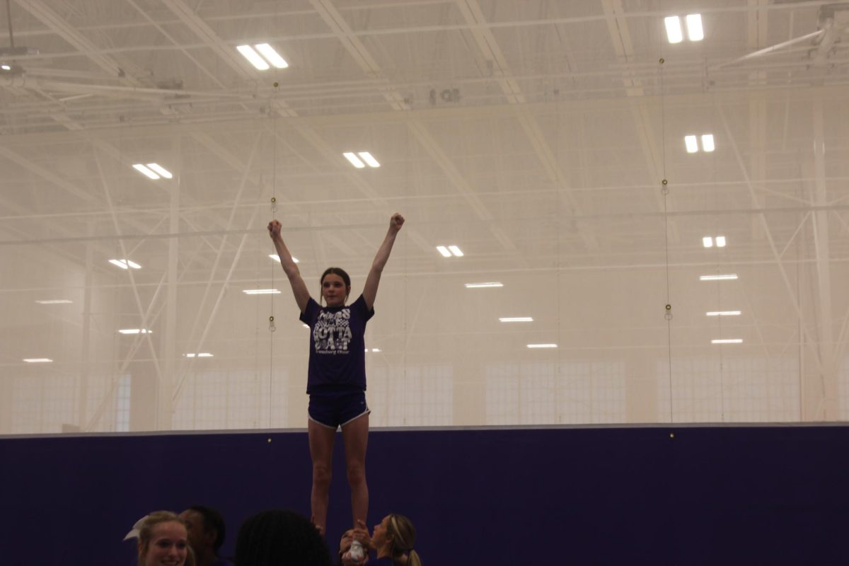 Freshman Aly Dunn is warming up with her stunt group for the 26-27 school year.